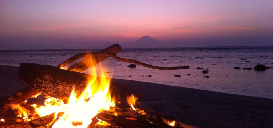 Having a bonfire on the beach while watching the most radiant sunset on the island of Gili Trawangan, Indonesia.